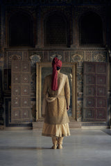GOLD MATKA SILK ANGRAKHA STYLE SHERWANI WITH CHANDERI BOOTI CHOGA AND CHURIDAR WITH OPTIONAL BELT, STOLE AND WORKED JUTIS