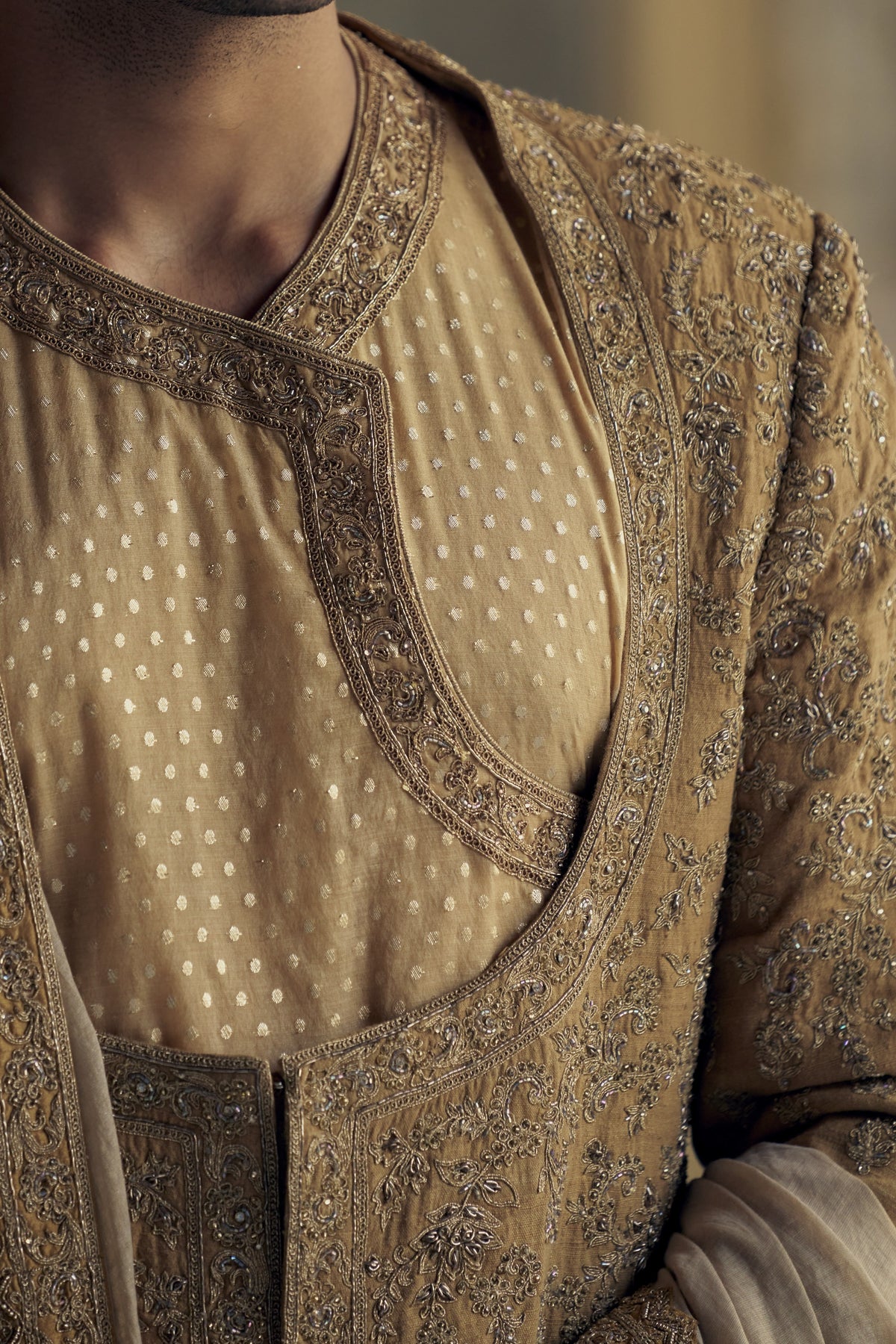 GOLD MATKA SILK ANGRAKHA STYLE SHERWANI WITH CHANDERI BOOTI CHOGA AND CHURIDAR WITH OPTIONAL BELT, STOLE AND WORKED JUTIS