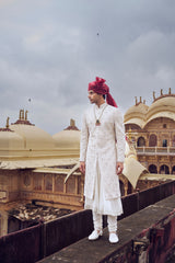 IVORY RAW SILK SHERWANI WITH COTTON SILK CHOGA AND CHURIDAR AND OPTIONAL STOLE, BELT AND WORKED JUTI