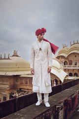 IVORY RAW SILK SHERWANI WITH COTTON SILK CHOGA AND CHURIDAR AND OPTIONAL STOLE, BELT AND WORKED JUTI