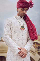 IVORY RAW SILK SHERWANI WITH COTTON SILK CHOGA AND CHURIDAR AND OPTIONAL STOLE, BELT AND WORKED JUTI