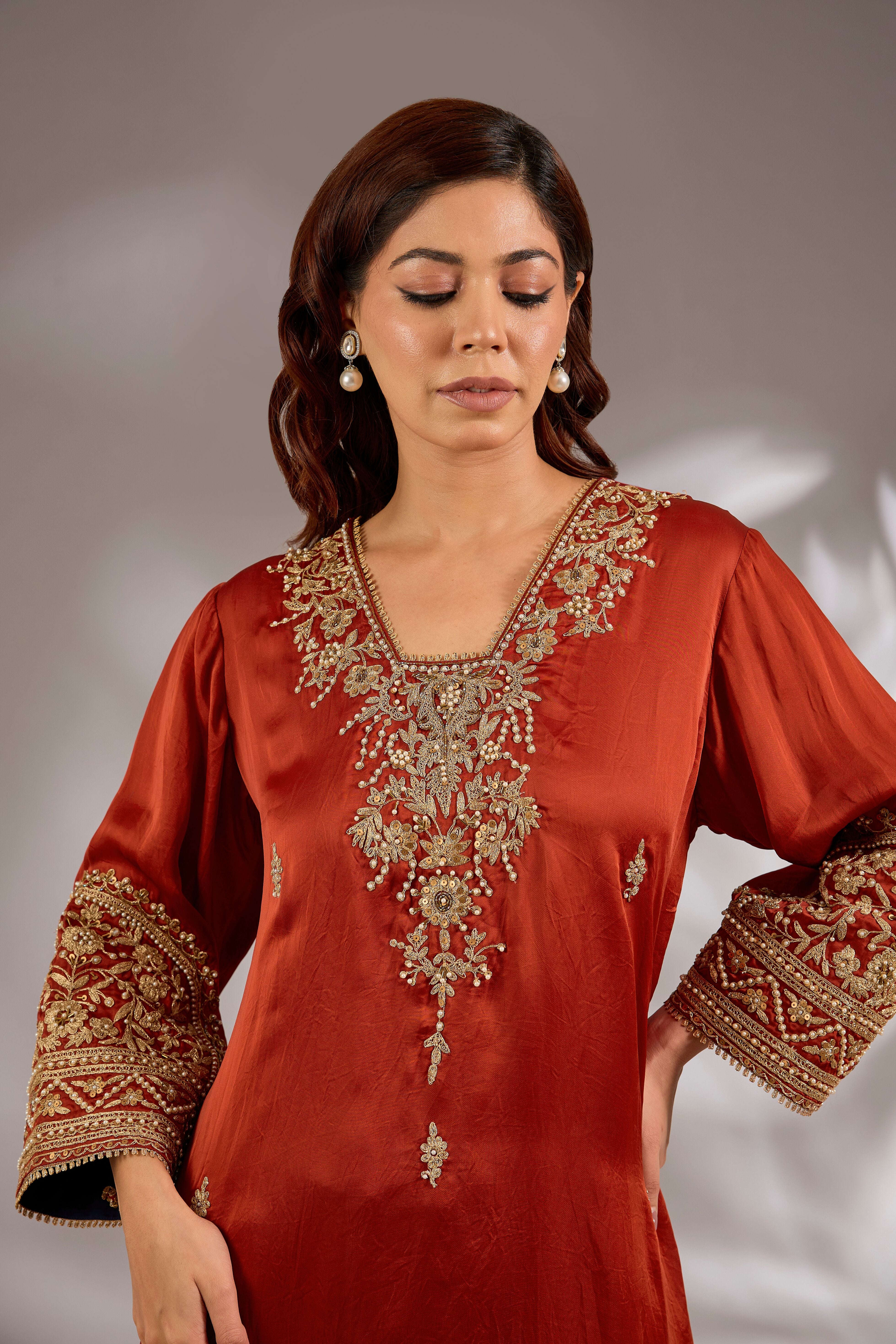 A-line kurta in satin organza base with dori hand embroidery.