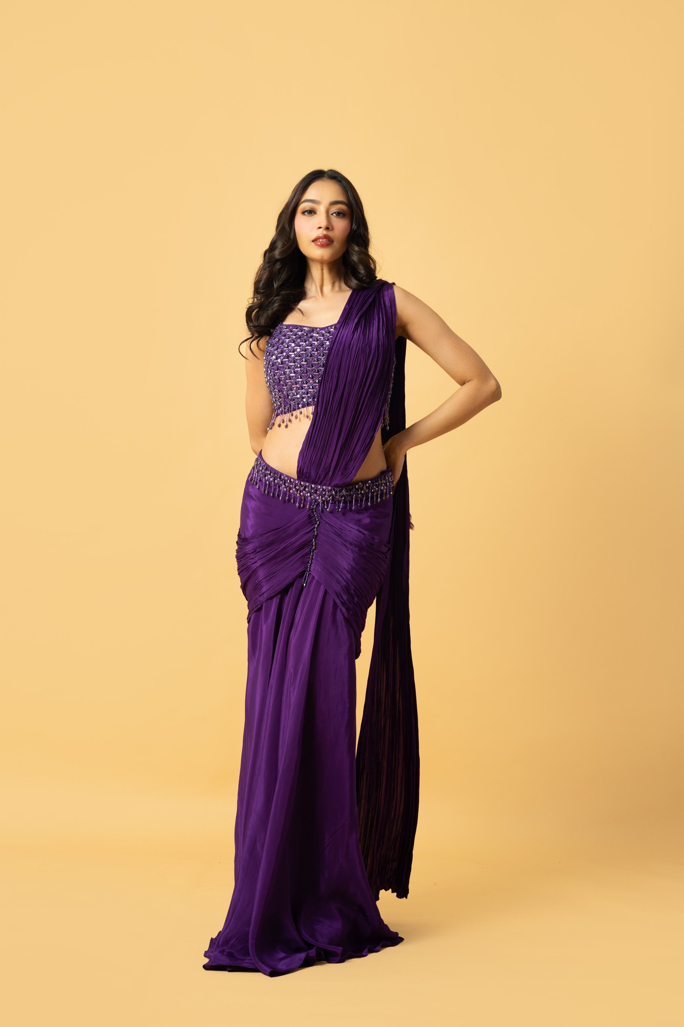 Violet crepe saree with hand embroidered sleeveless blouse