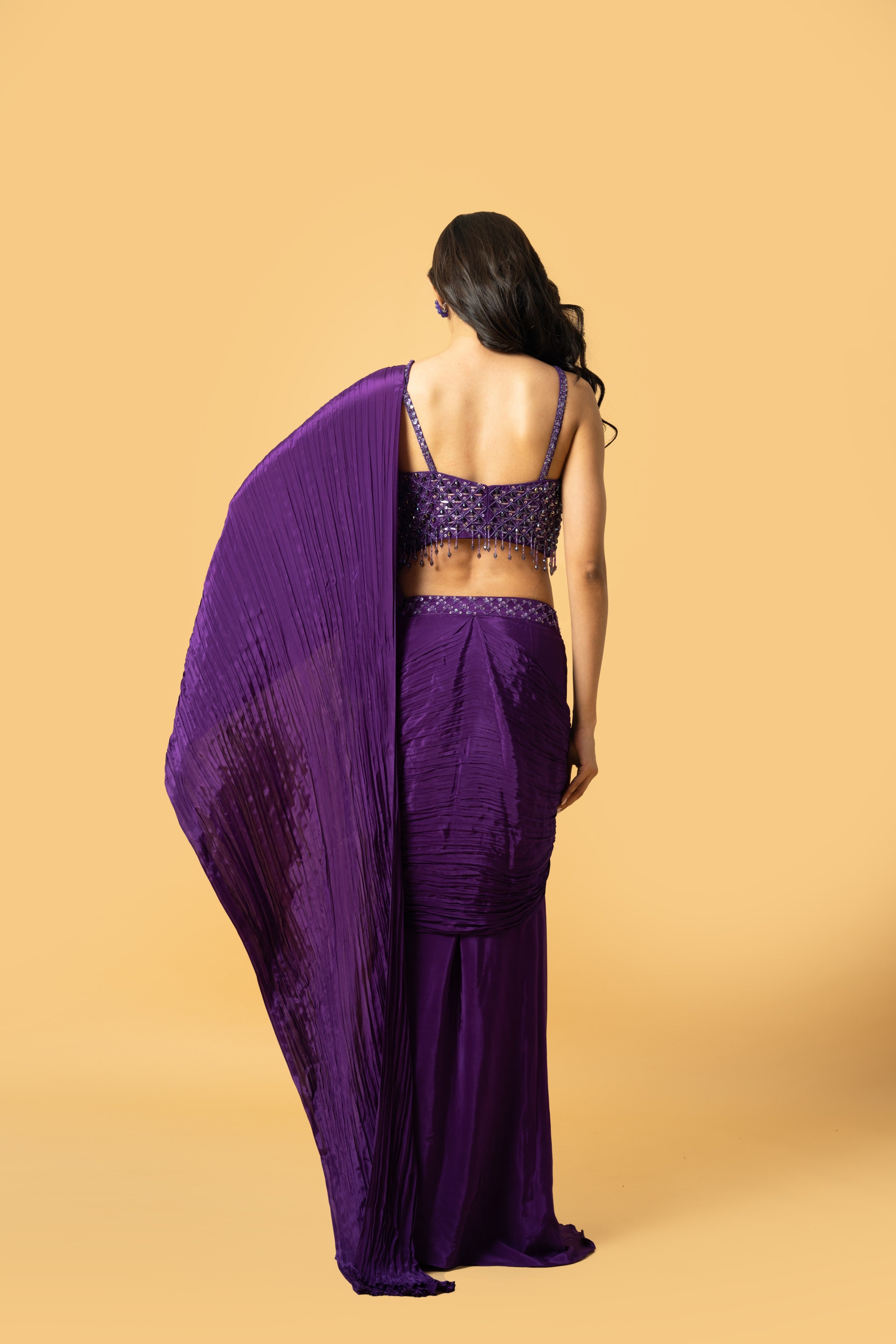 Violet crepe saree with hand embroidered sleeveless blouse