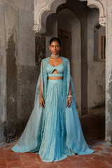 A pwder blue lehenga with maching blouse and cape