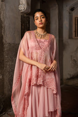 A baby pink jacket set paired with bustier and skirt