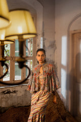 A jumpsuit paired with hand embroired cape