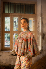 A jumpsuit paired with hand embroired cape