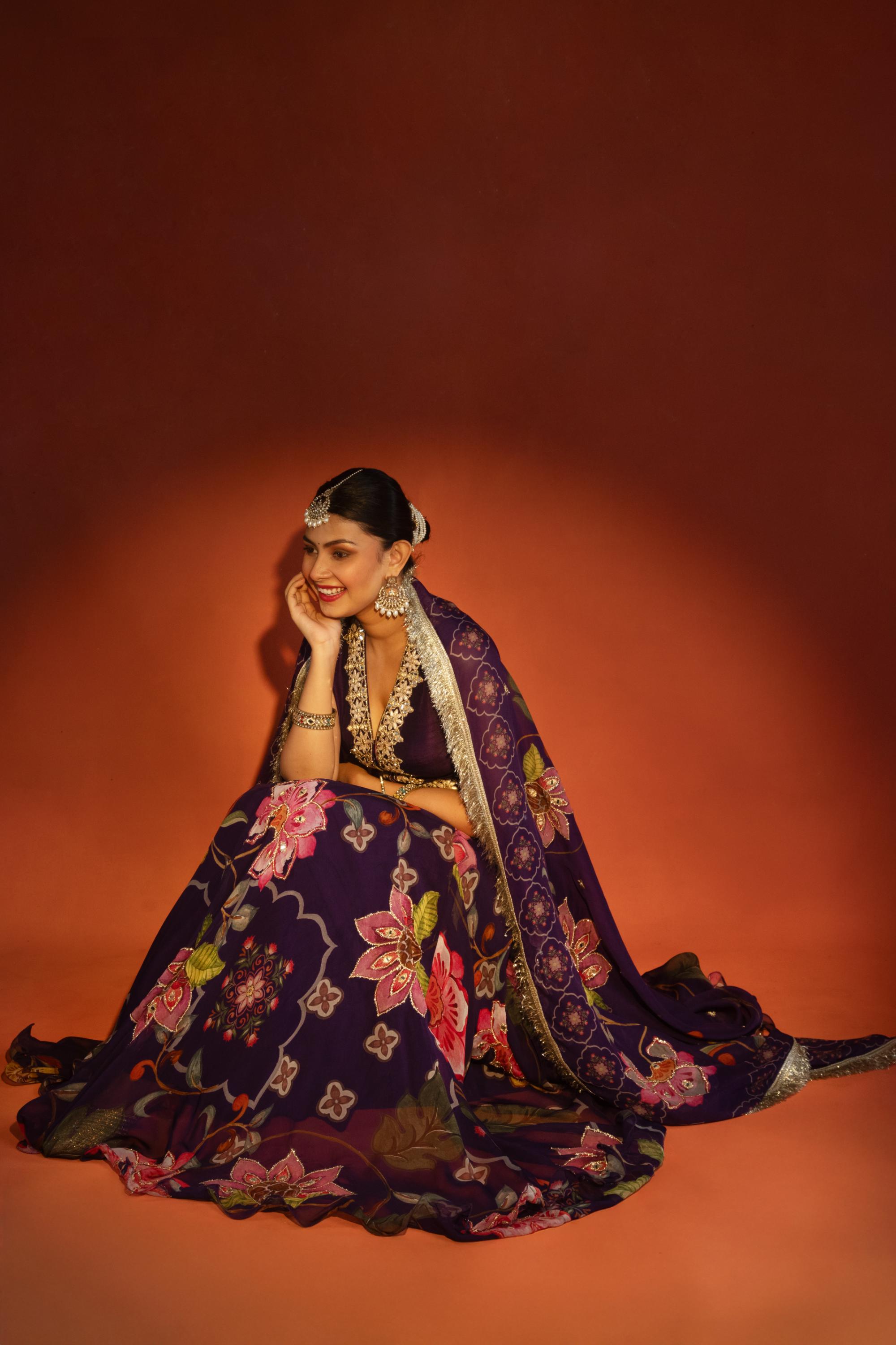 Purple floral lehenga with mirror-work waistcoat and placement dupatta.