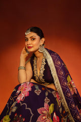 Purple floral lehenga with mirror-work waistcoat and placement dupatta.