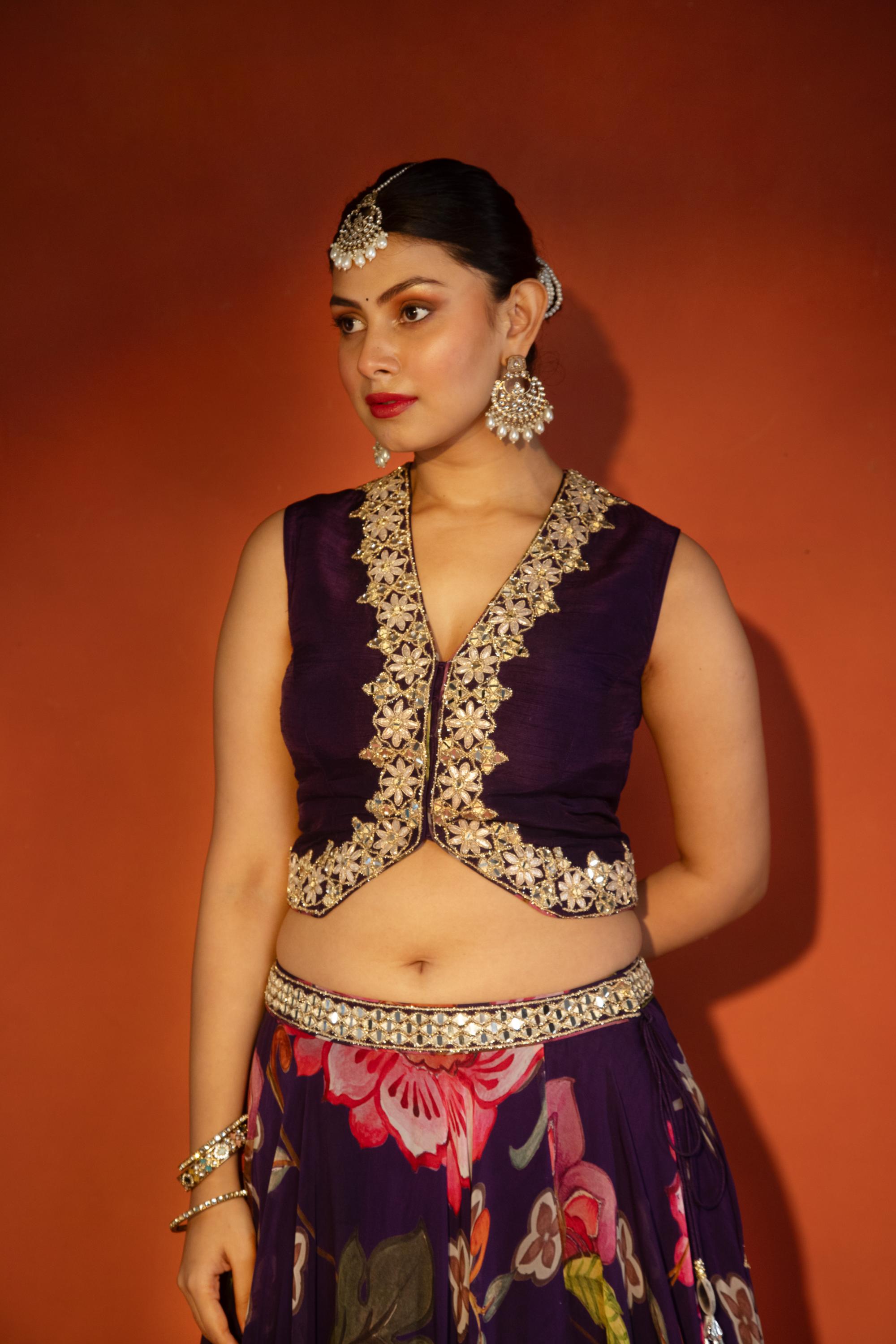 Purple floral lehenga with mirror-work waistcoat and placement dupatta.