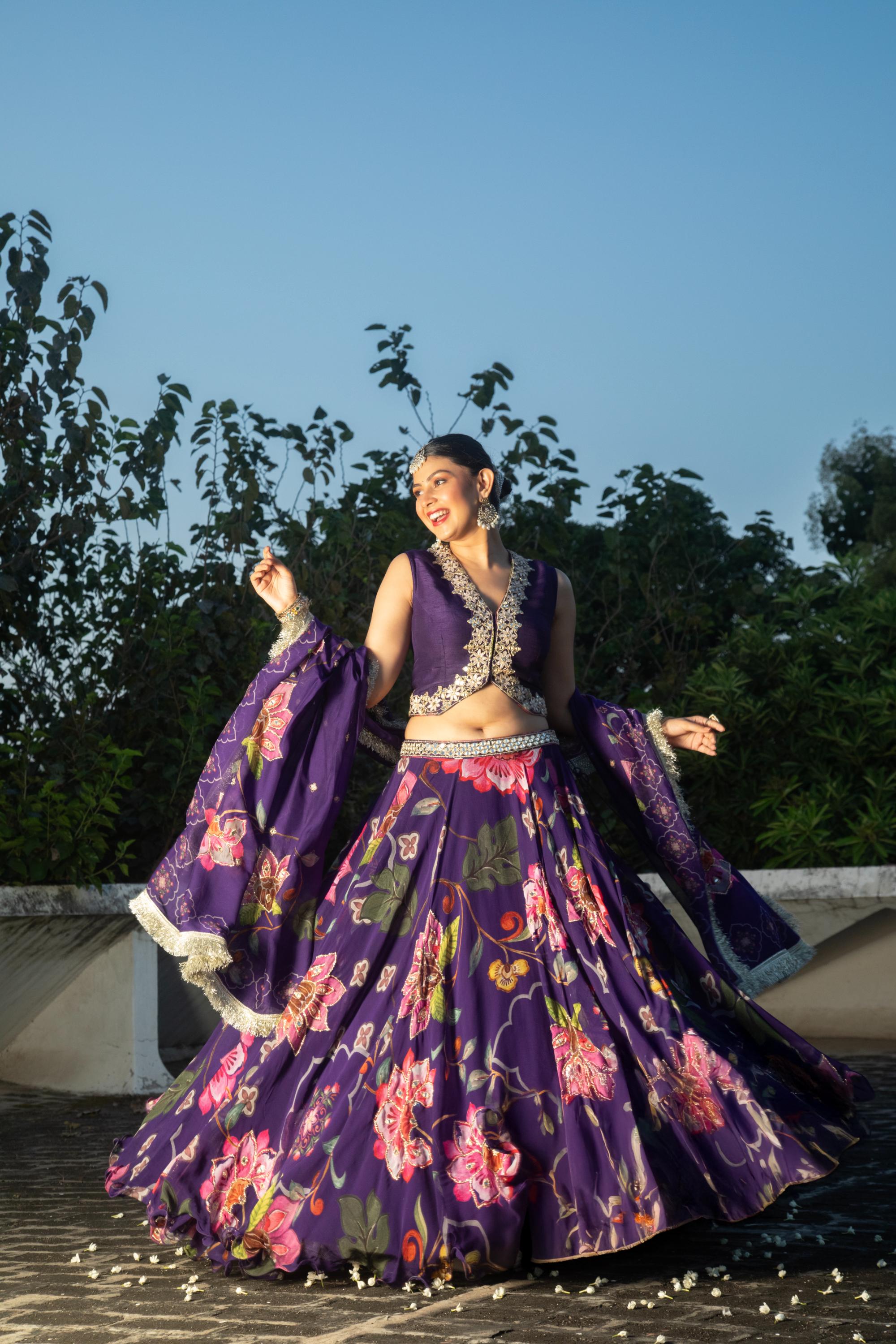Purple floral lehenga with mirror-work waistcoat and placement dupatta.