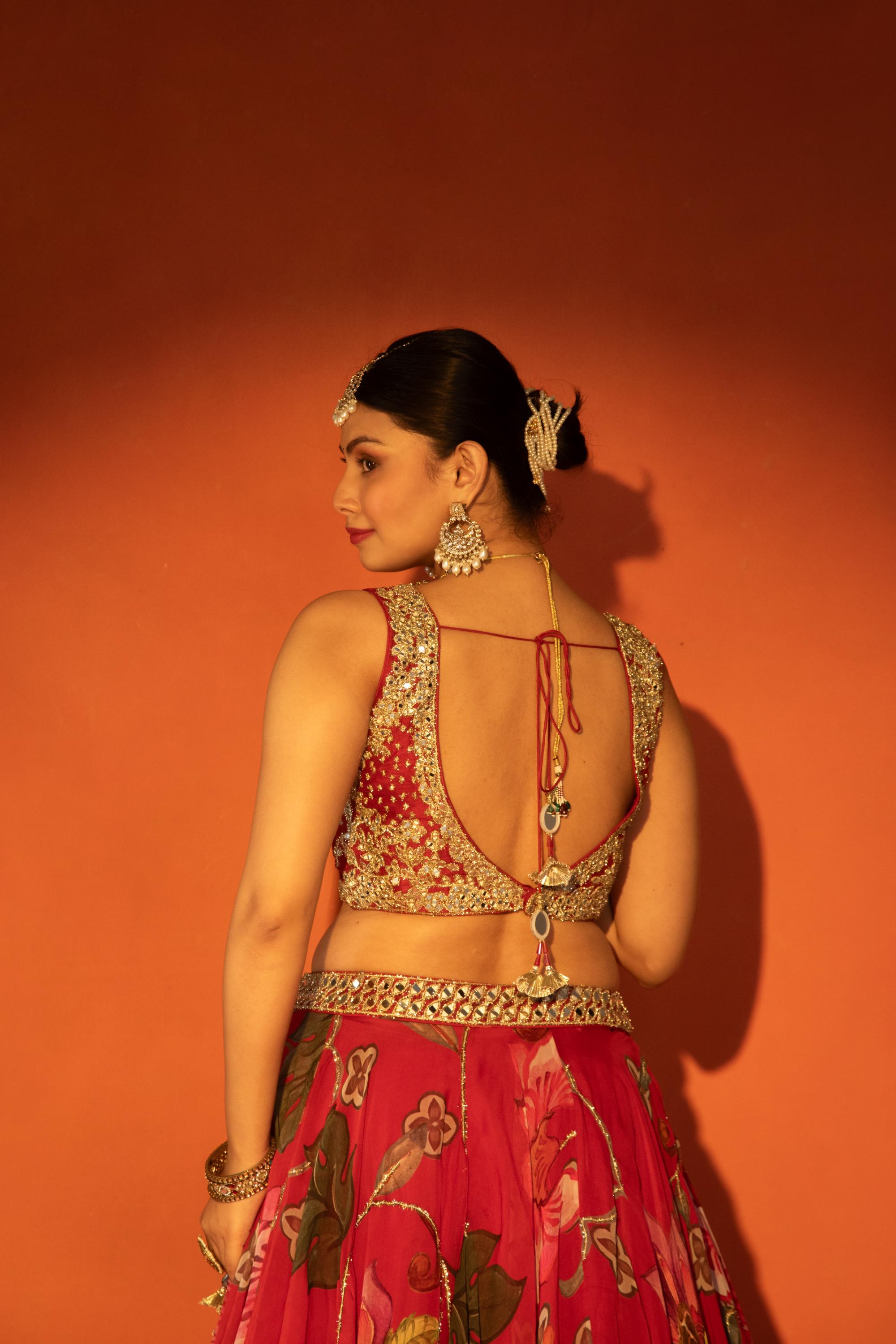 Red floral lehenga with mirror-work blouse and placement dupatta.