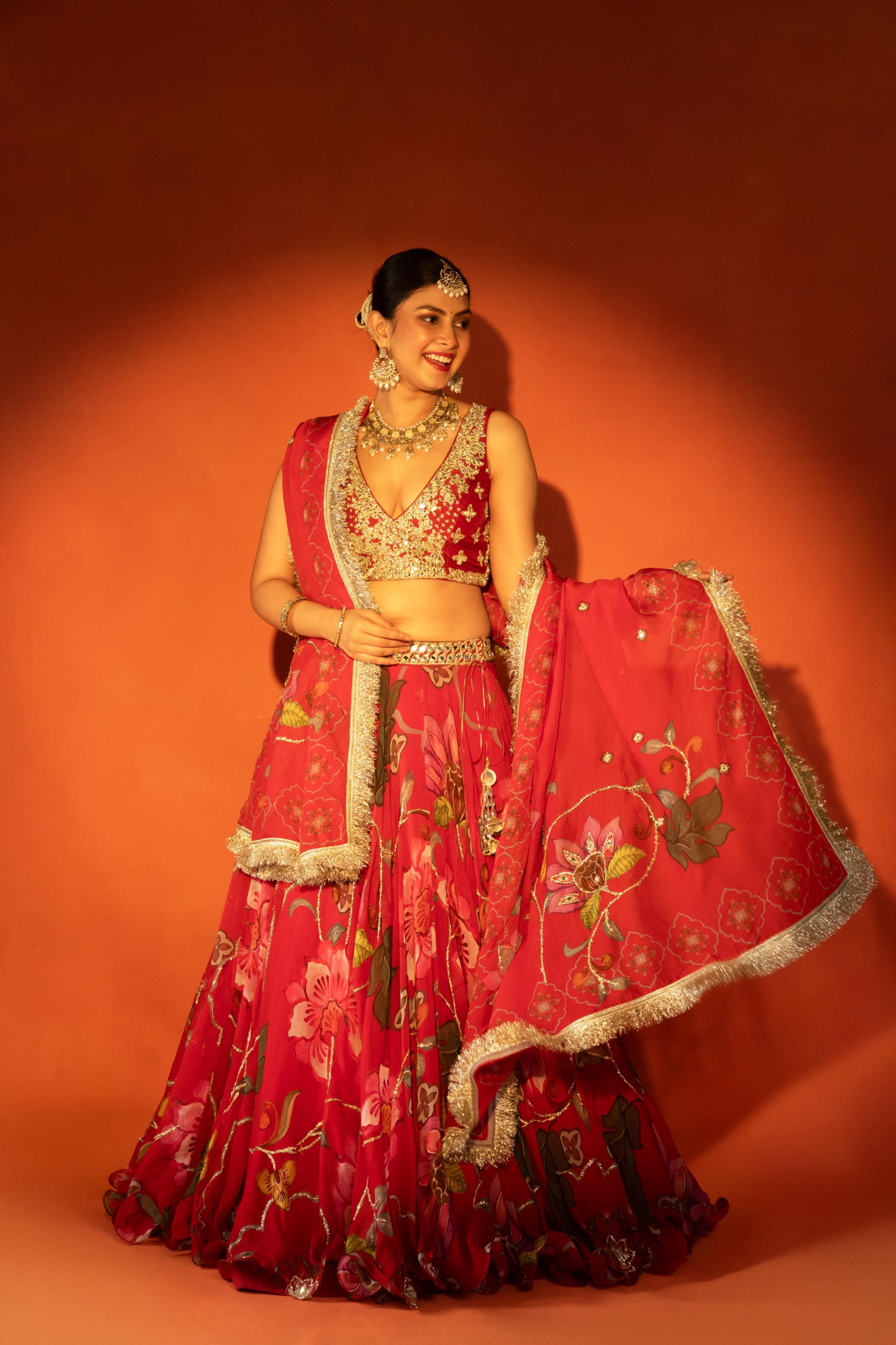 Red floral lehenga with mirror-work blouse and placement dupatta.