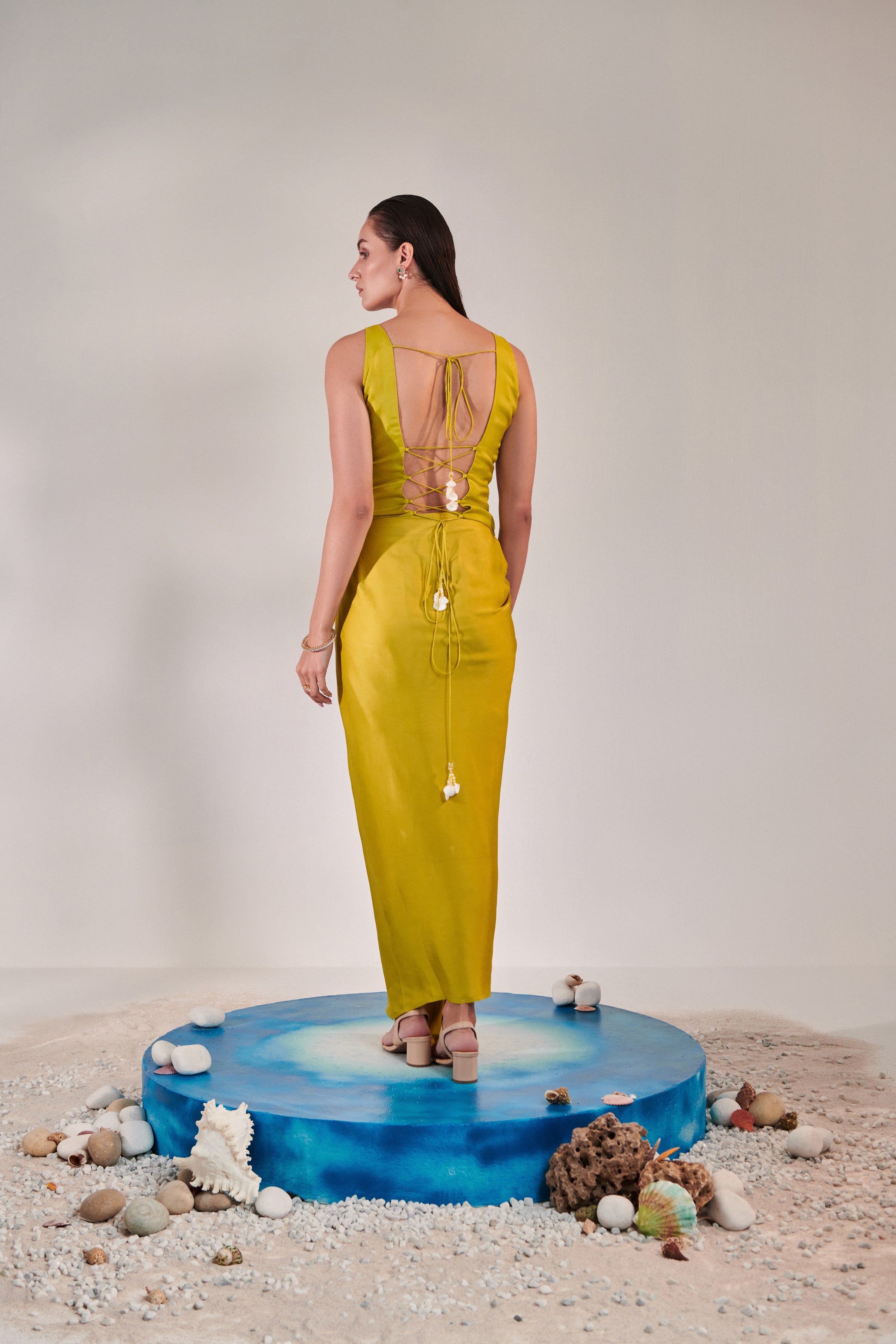 Sleeveless jacket and drape skirt